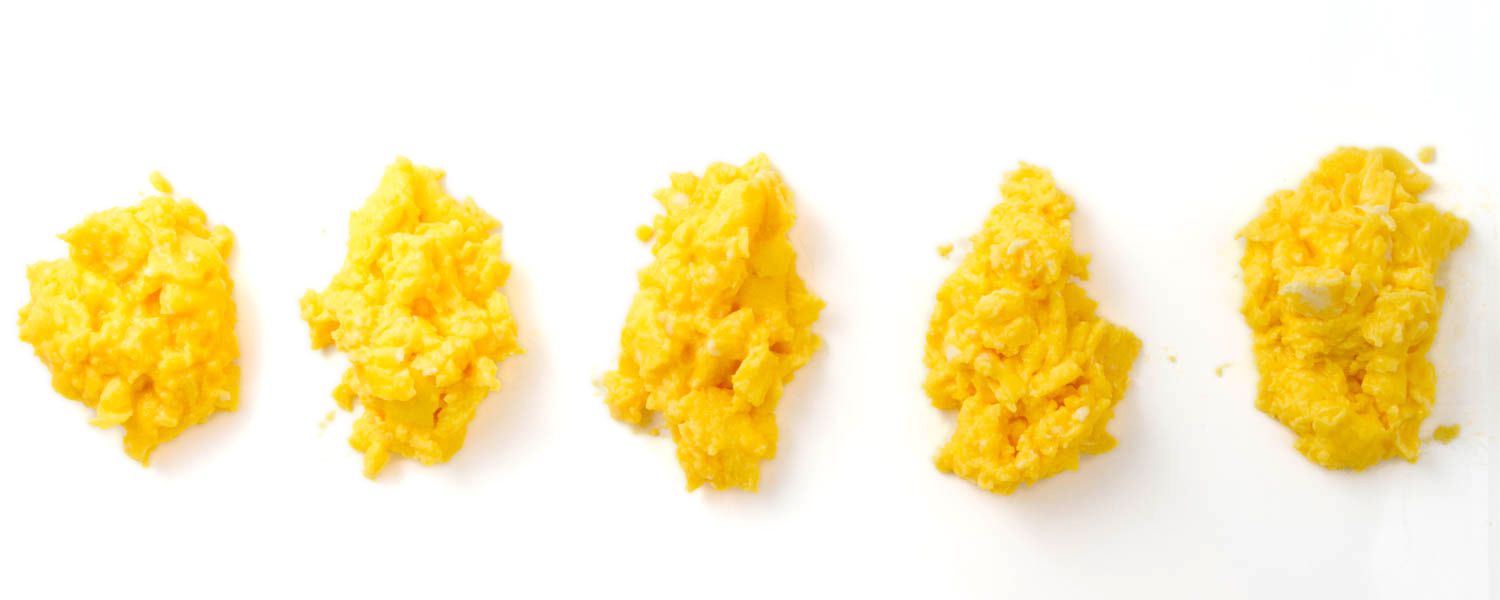 A series of scrambled eggs each with salt added at different points.