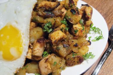 Chicken and potato hash with a fried egg.