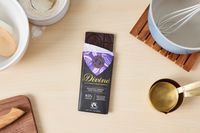 A partially unwrapped Divine extra-dark chocolate bar.
