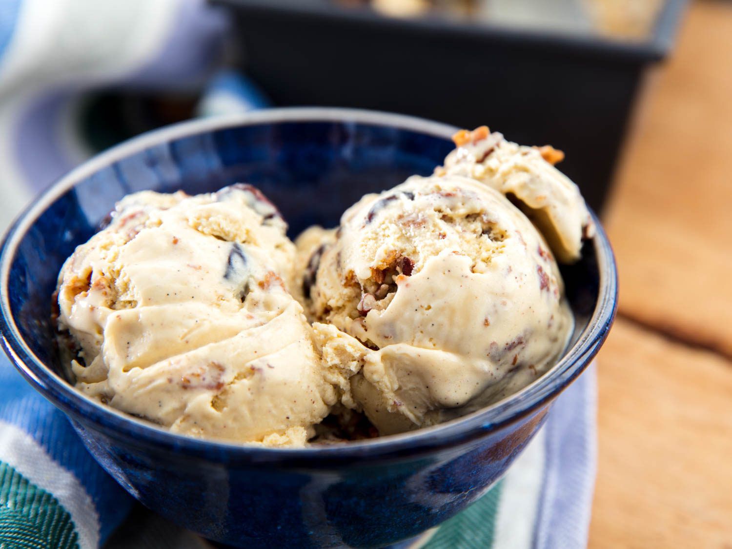 Two scoops of oatmeal cookie ice cream in a blue bowl.