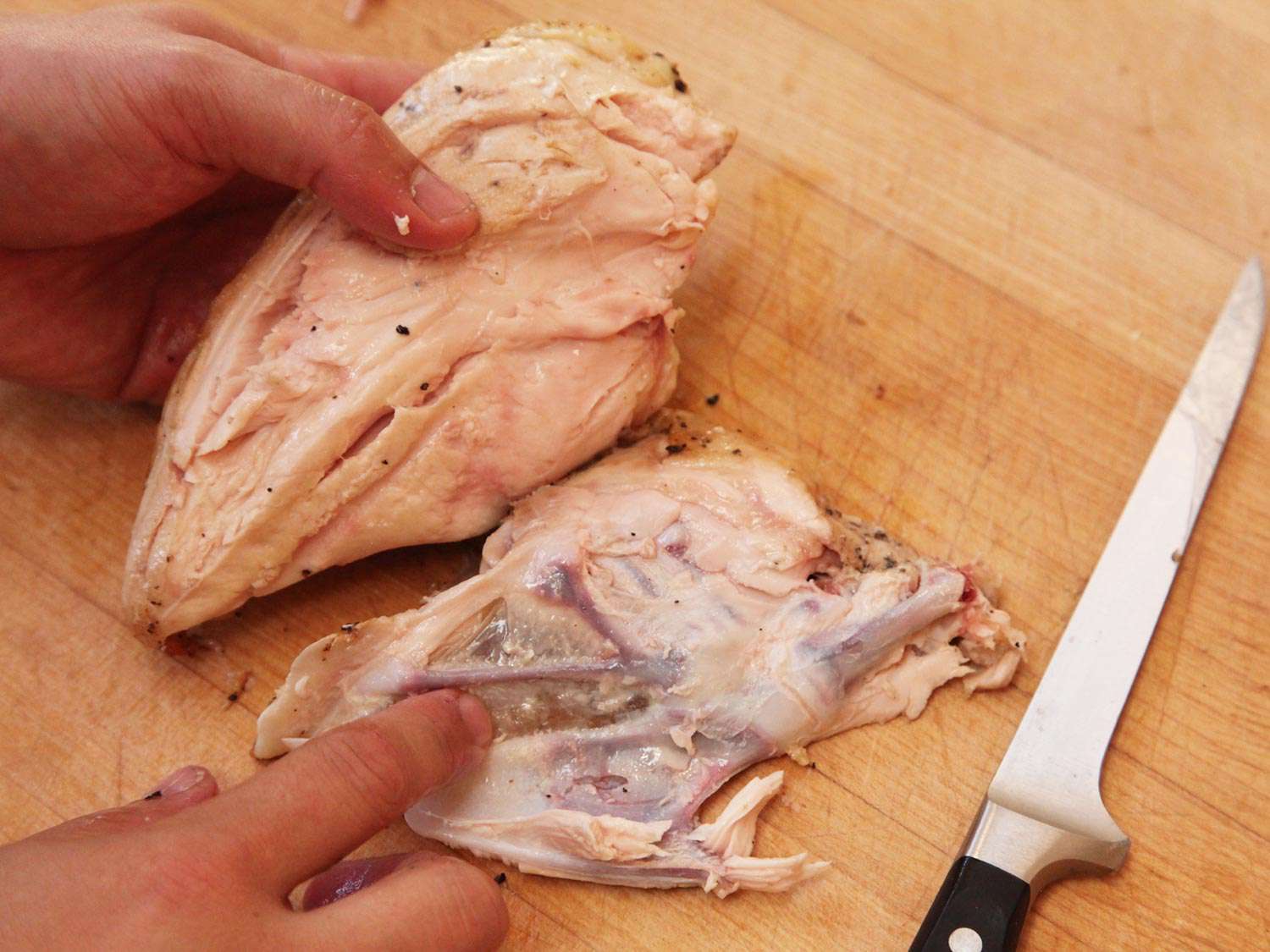 Removing ribs and breastbone from a chicken breast cooked sous vide and finished on the stovetop.