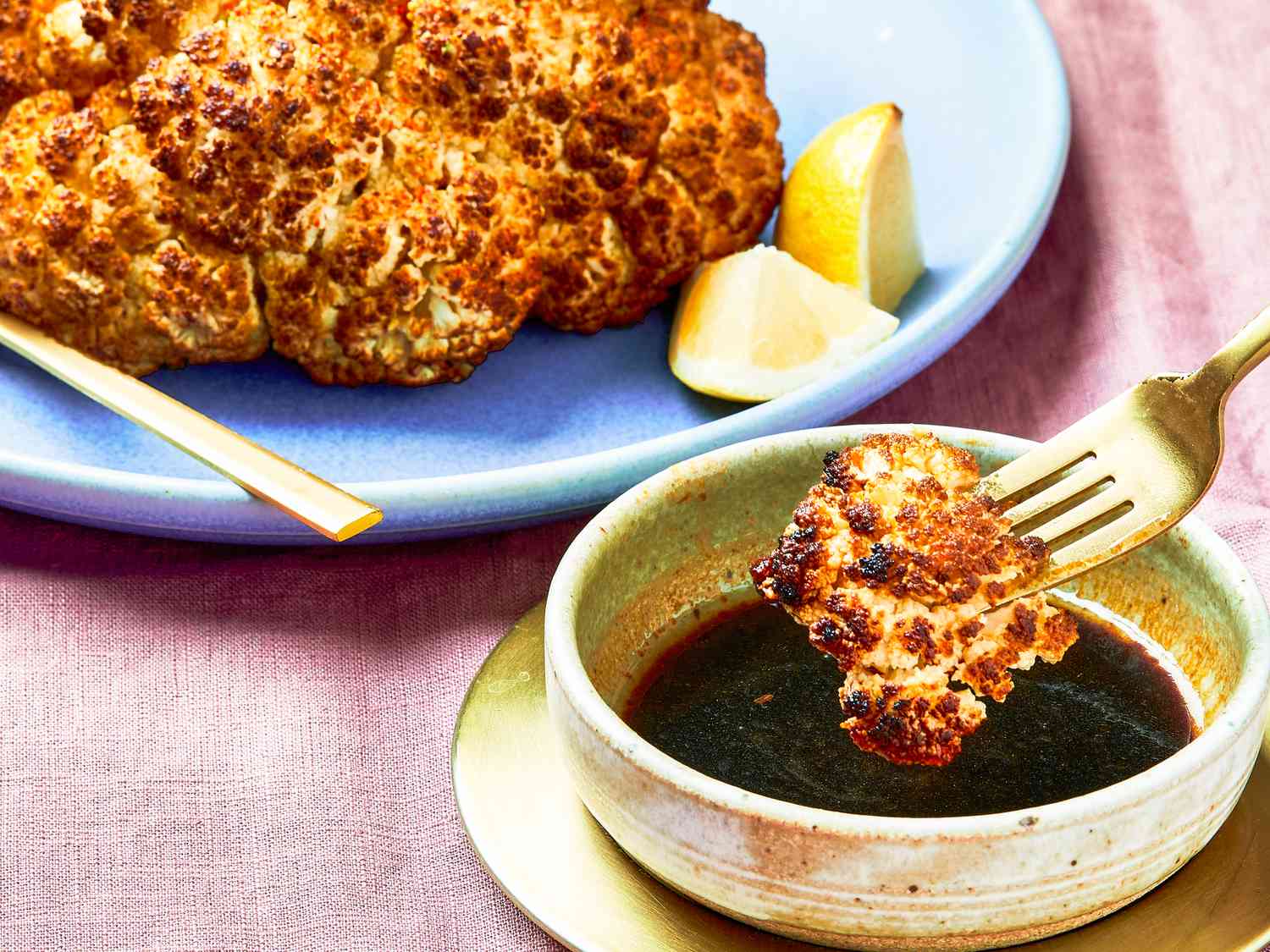 Side view of dipping cauliflower in sauce