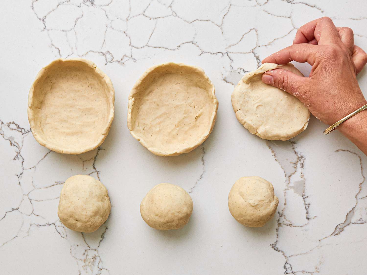 Overhead view of sopes being formed by hand.