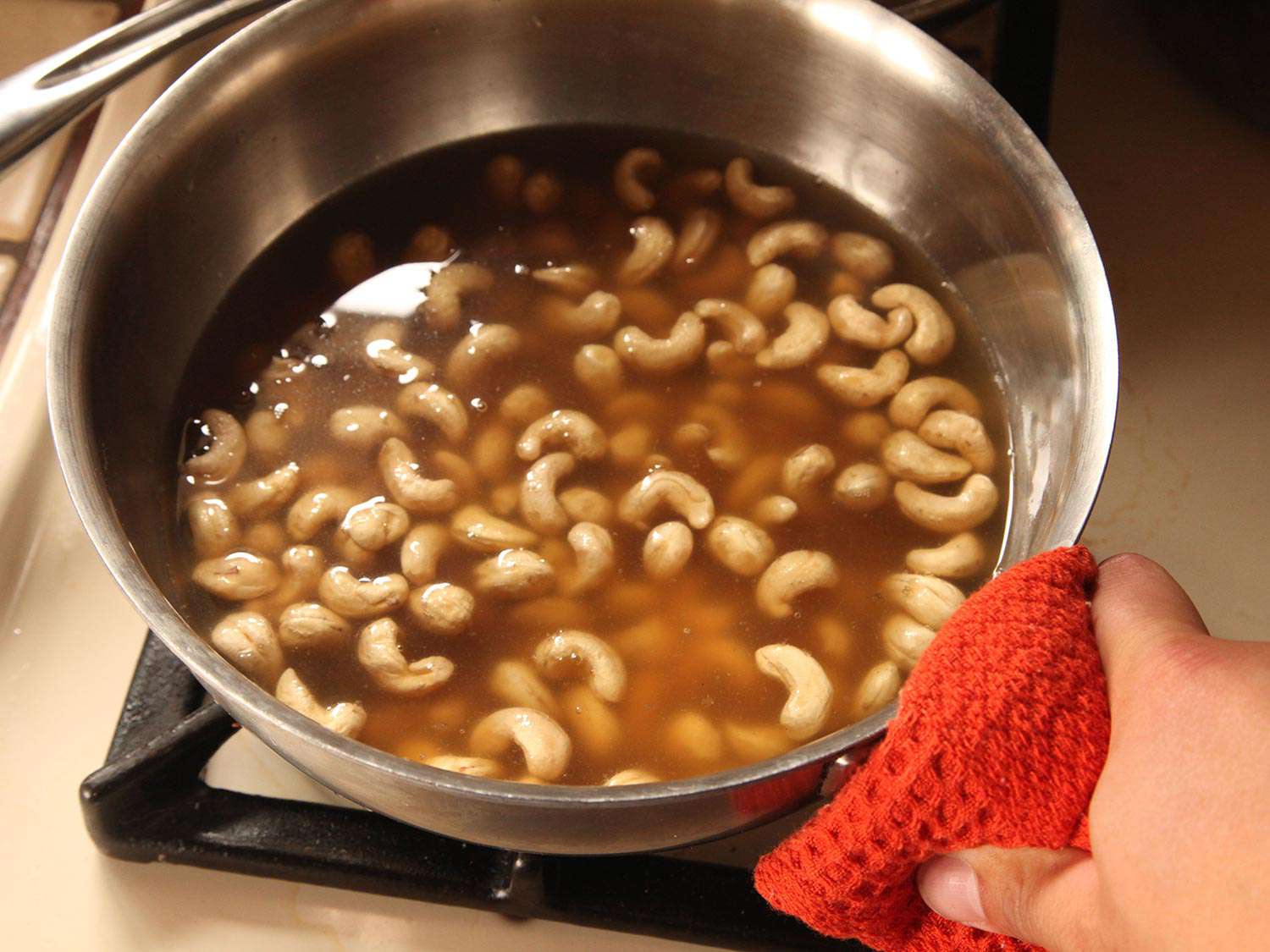 Cooking cashews in vegetable stock.