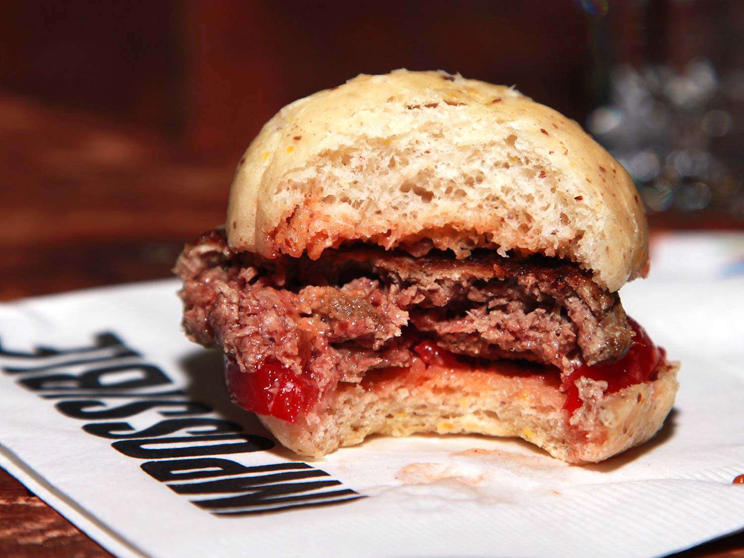 A bite taken out of an Impossible Burger slider. 