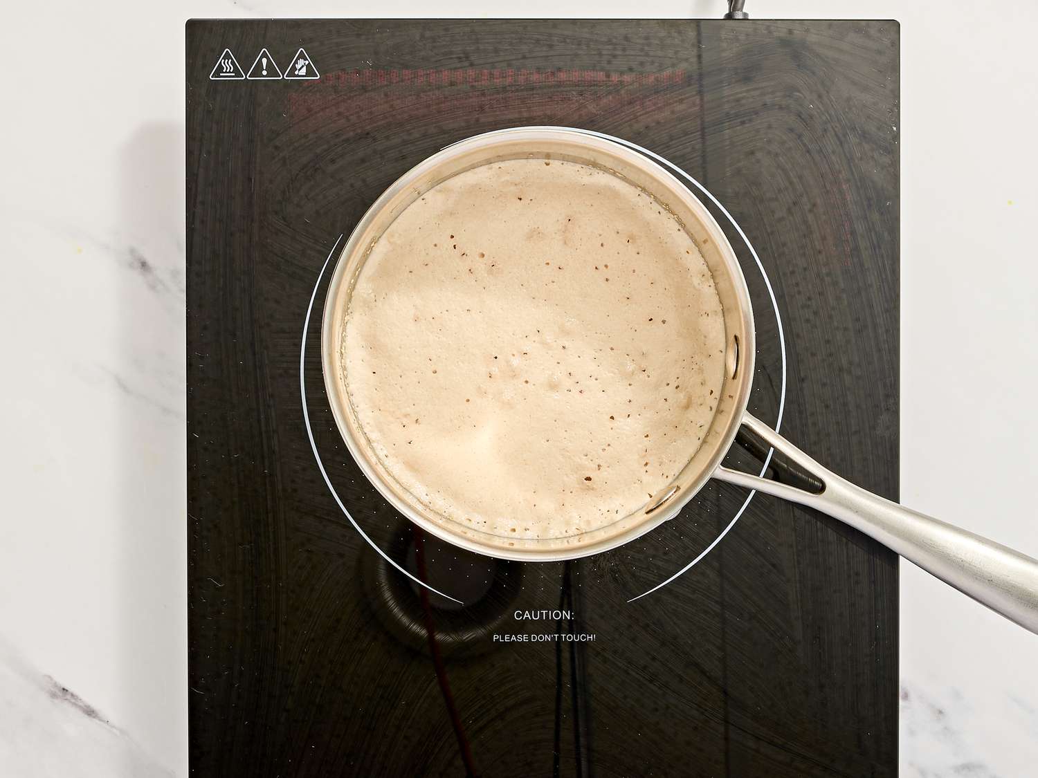 Saucepan with batter on an induction cooktop