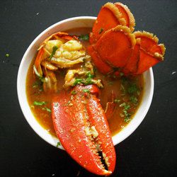 Overhead of lobster in yellow curry sauce. 