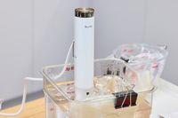 Breville Joule Turbo Sous Vide Machine in a water bath setup for sous vide cooking