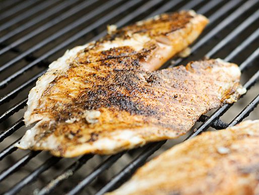 A grilled fish steak on a grill.