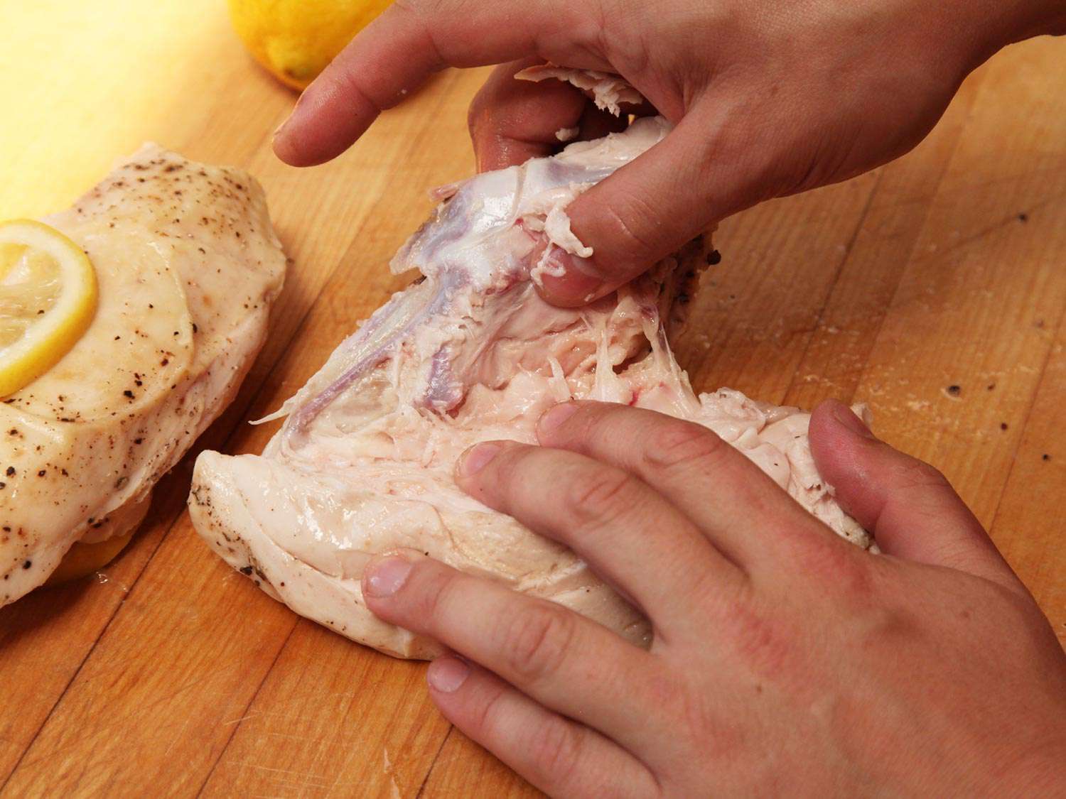Removing bones from a sous vide chicken breast.