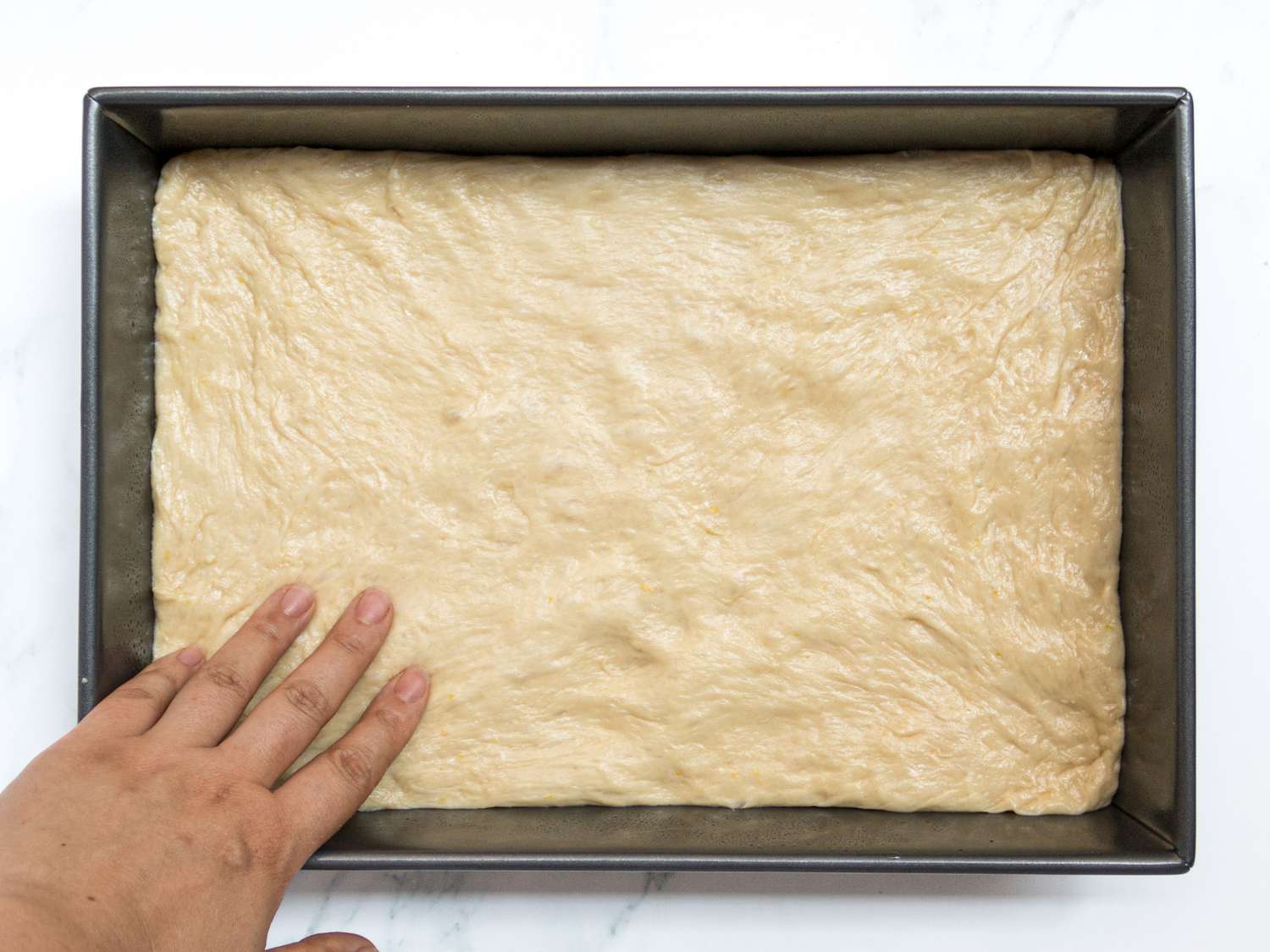 Dough pressed evenly into baking pan 