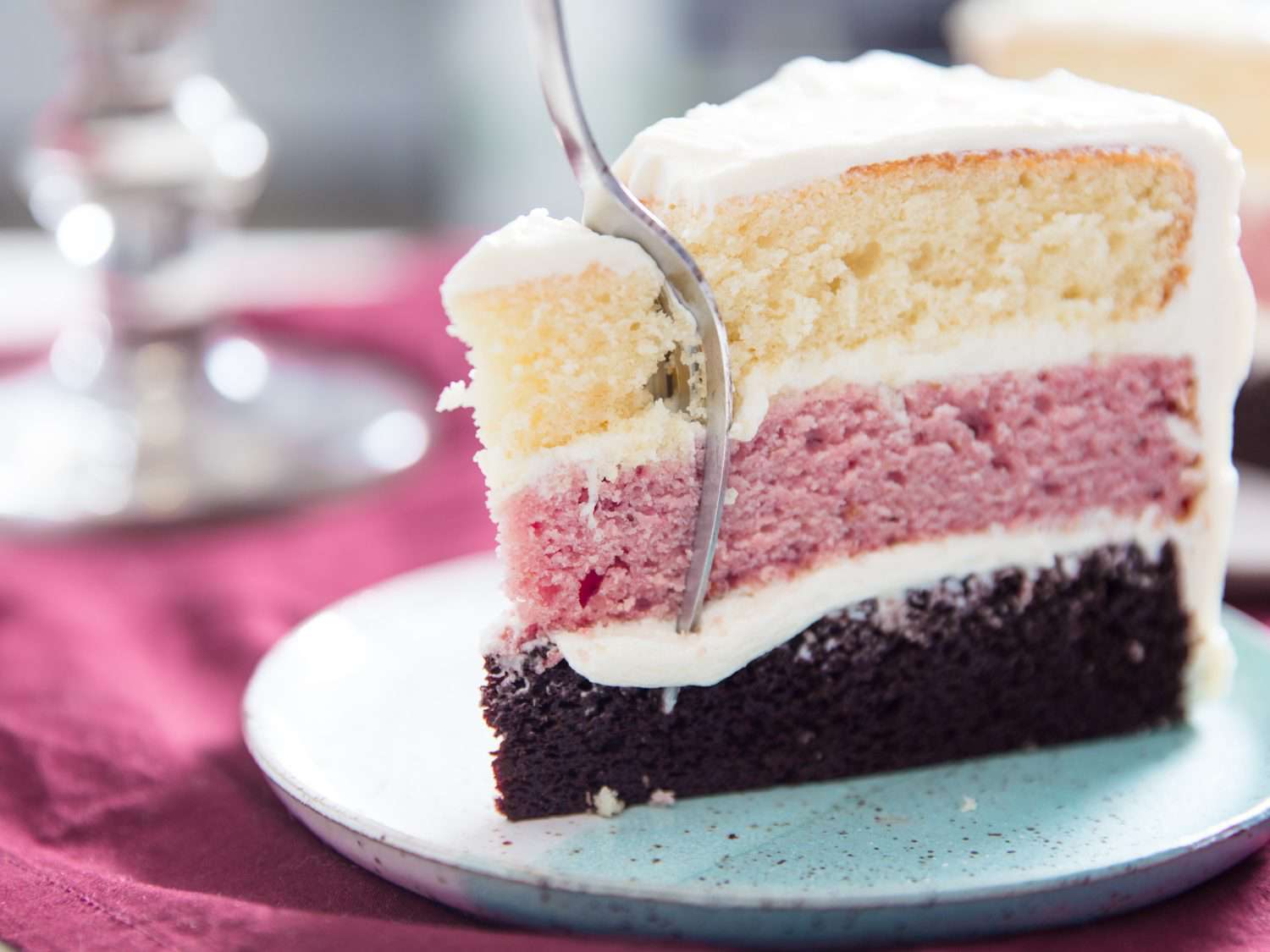 slice of Neapolitan layer cake with a fork