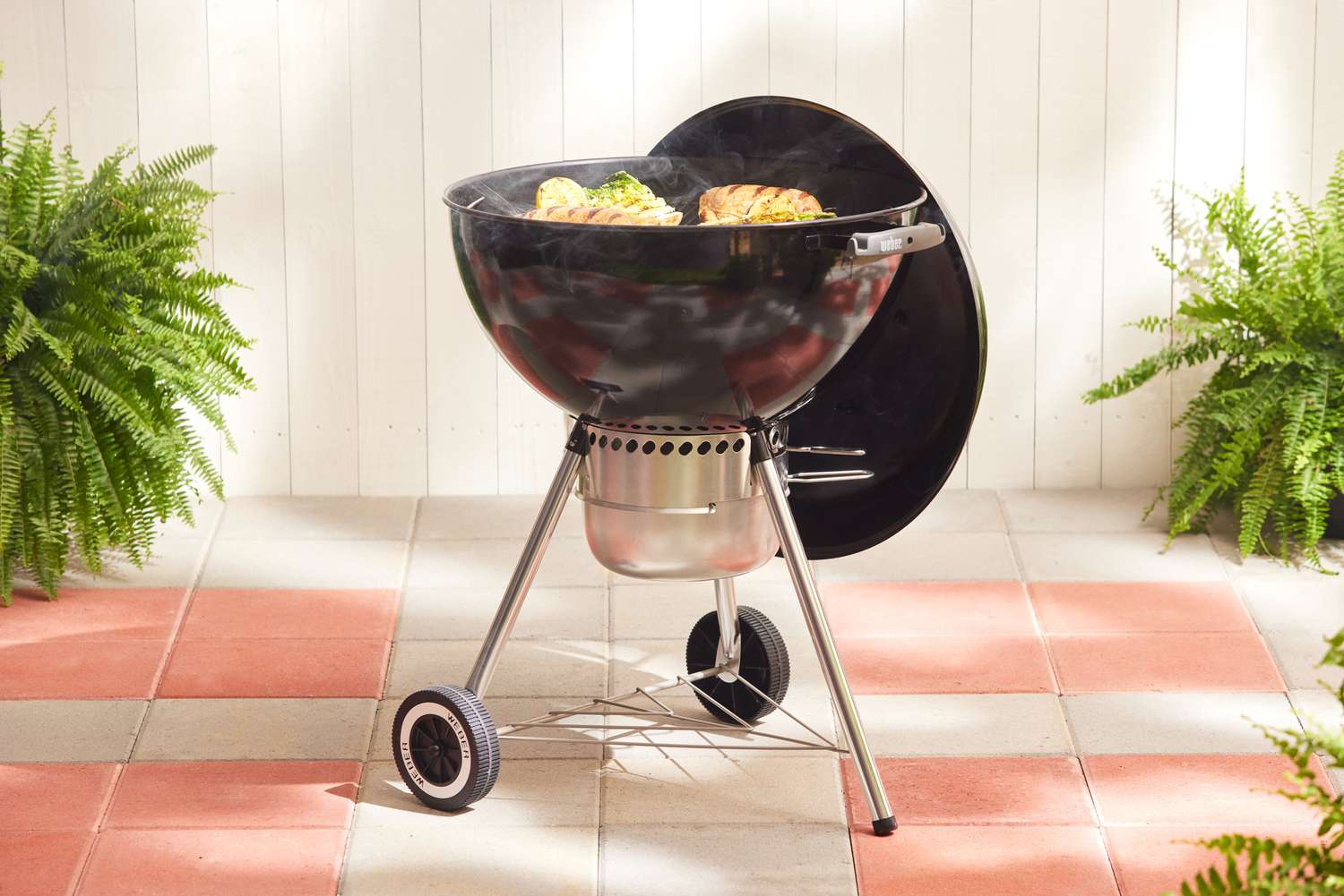 The Weber Original Kettle Grill on a tiled patio