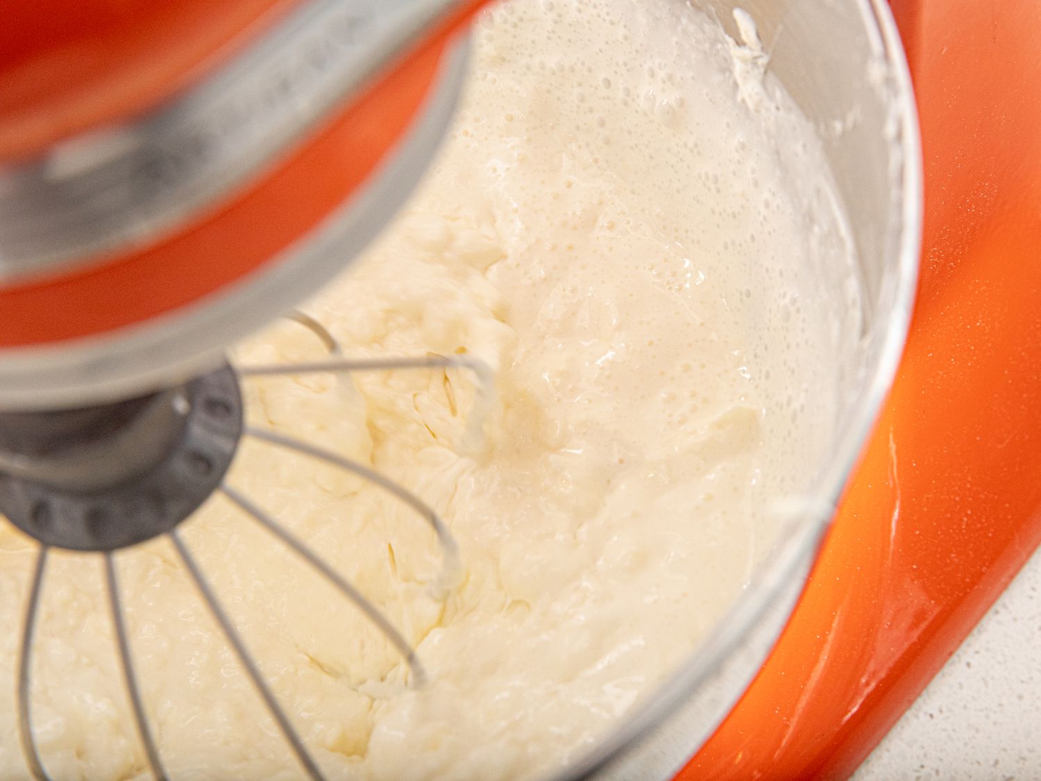 Overhead view of cream added to stand mixer