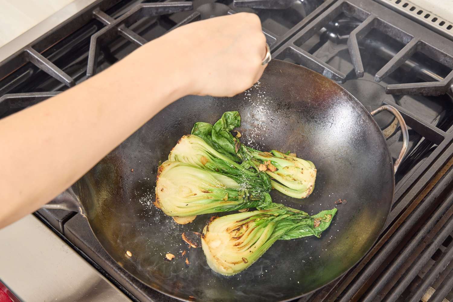 Bok choi is cooked in the Yosukata Carbon Steel Wok Pan