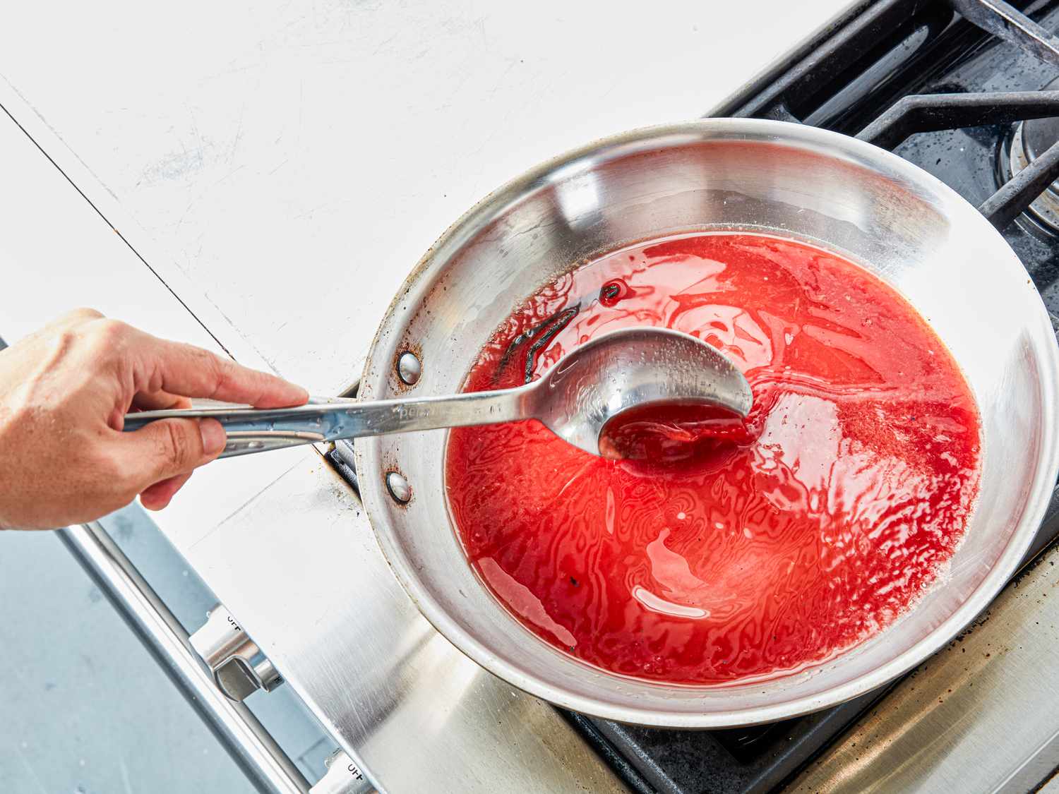 Overhead view of stirring cherrie juice 