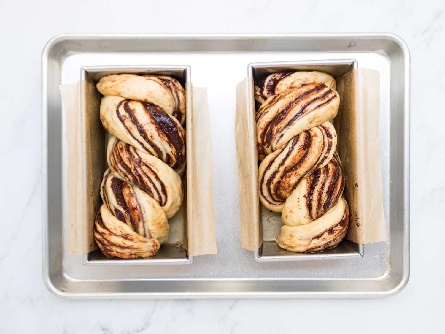 two twisted babkas in loaf pans