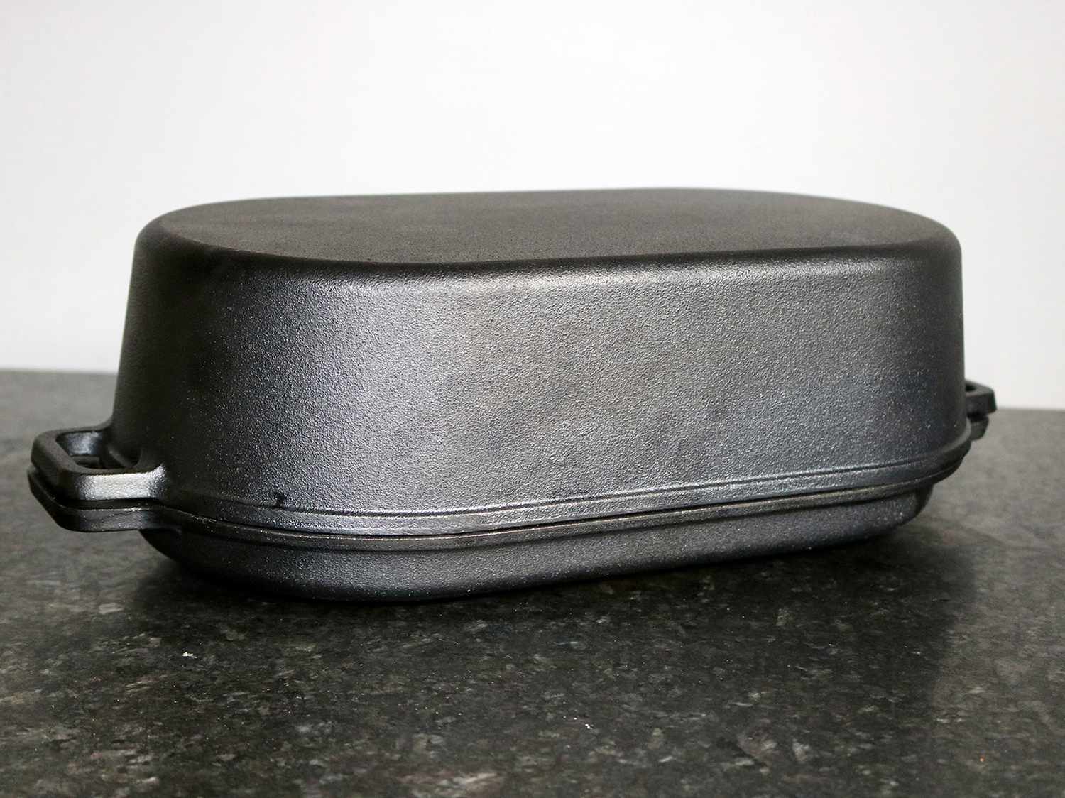 a Pit Boss Cast Iron Roaster sits on a granite counter top 