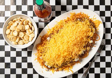 Overhead view of cincinnati chili on a black and white checkered background