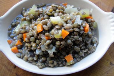 A small dish of cooked basic French green lentils. 