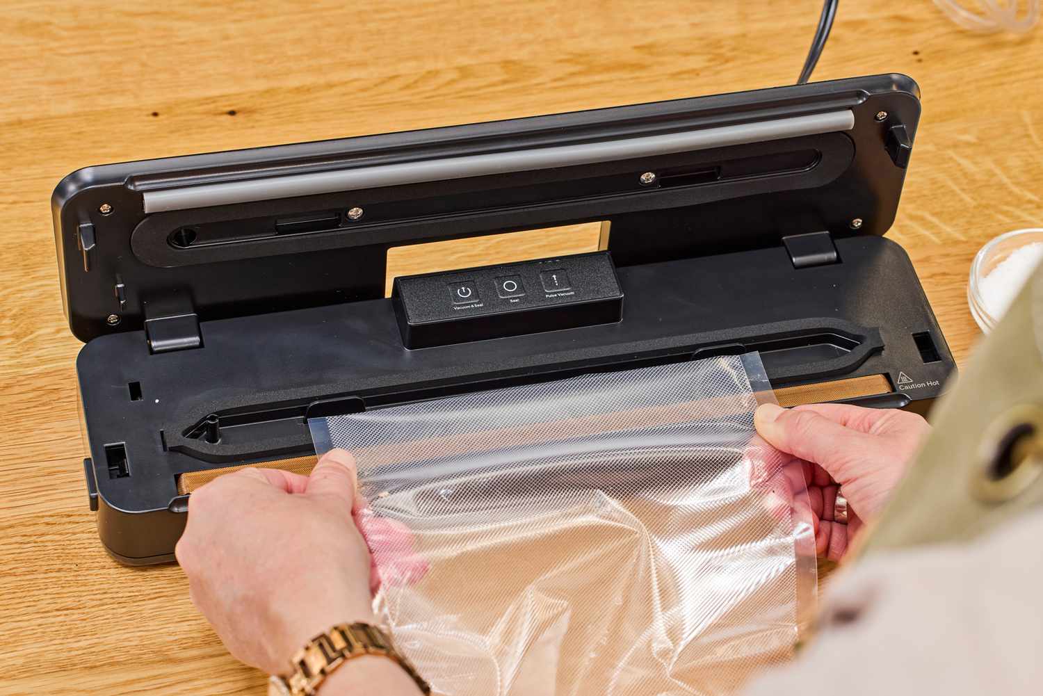A person creates a plastic bag using the Anova Precision Sous Vide Vacuum Sealer