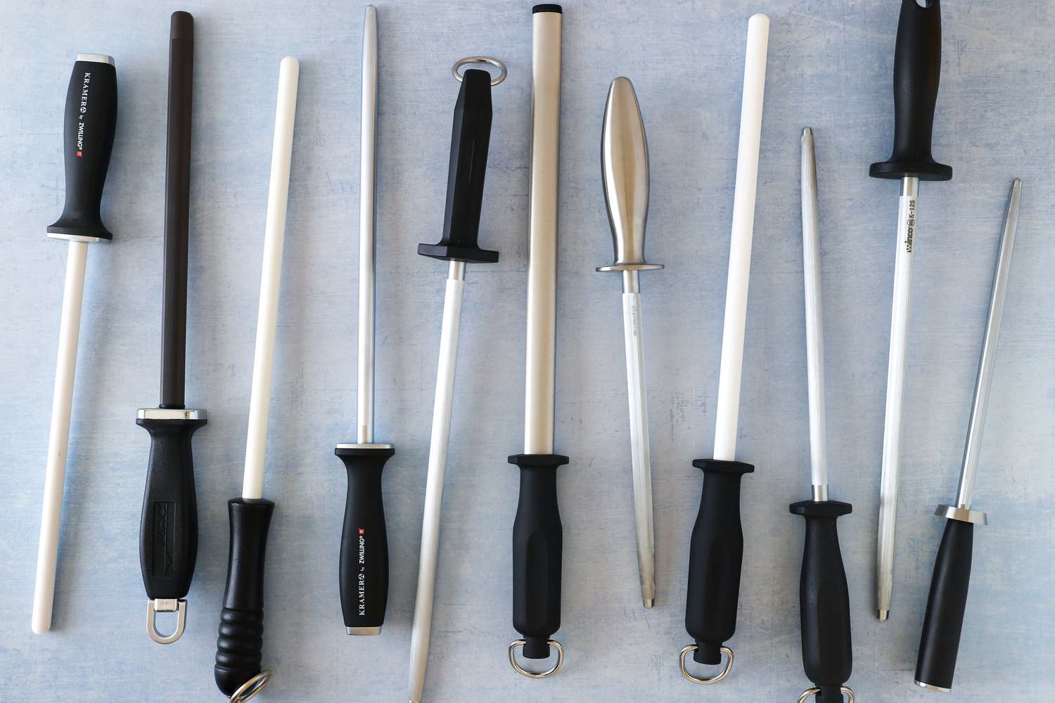 a bunch of honing rods on a pale blue background