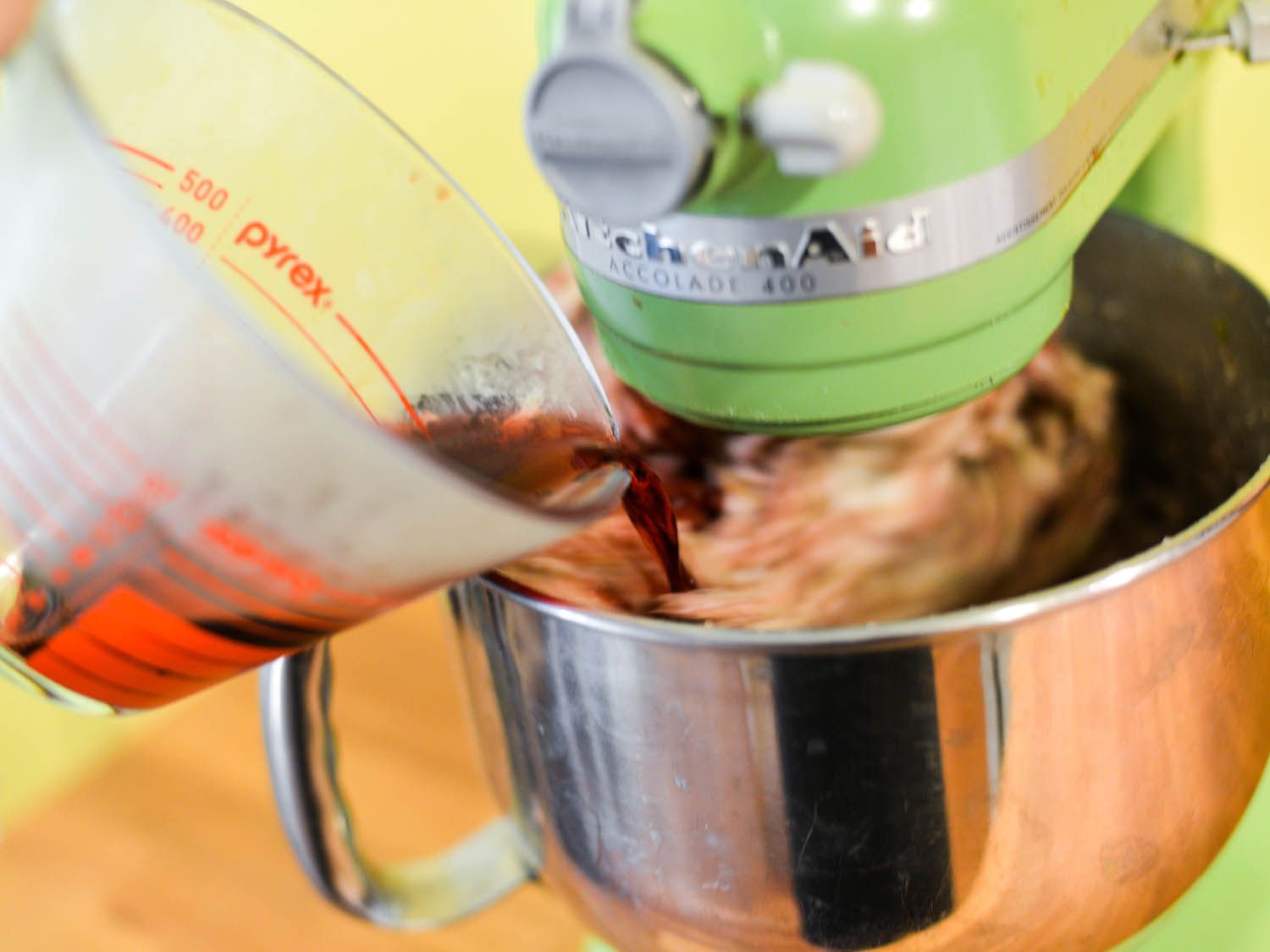 Chilled wine and vinegar are added to the sausage forcemeat as it is mixed.