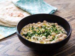 bowl of hummus masbacha with pita bread