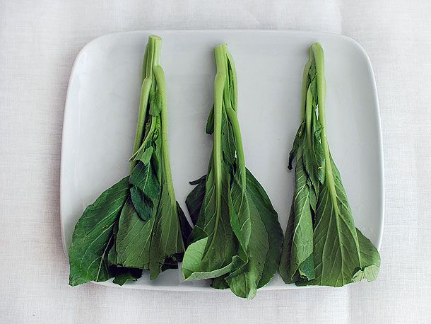 A plate with raw choy sum. 