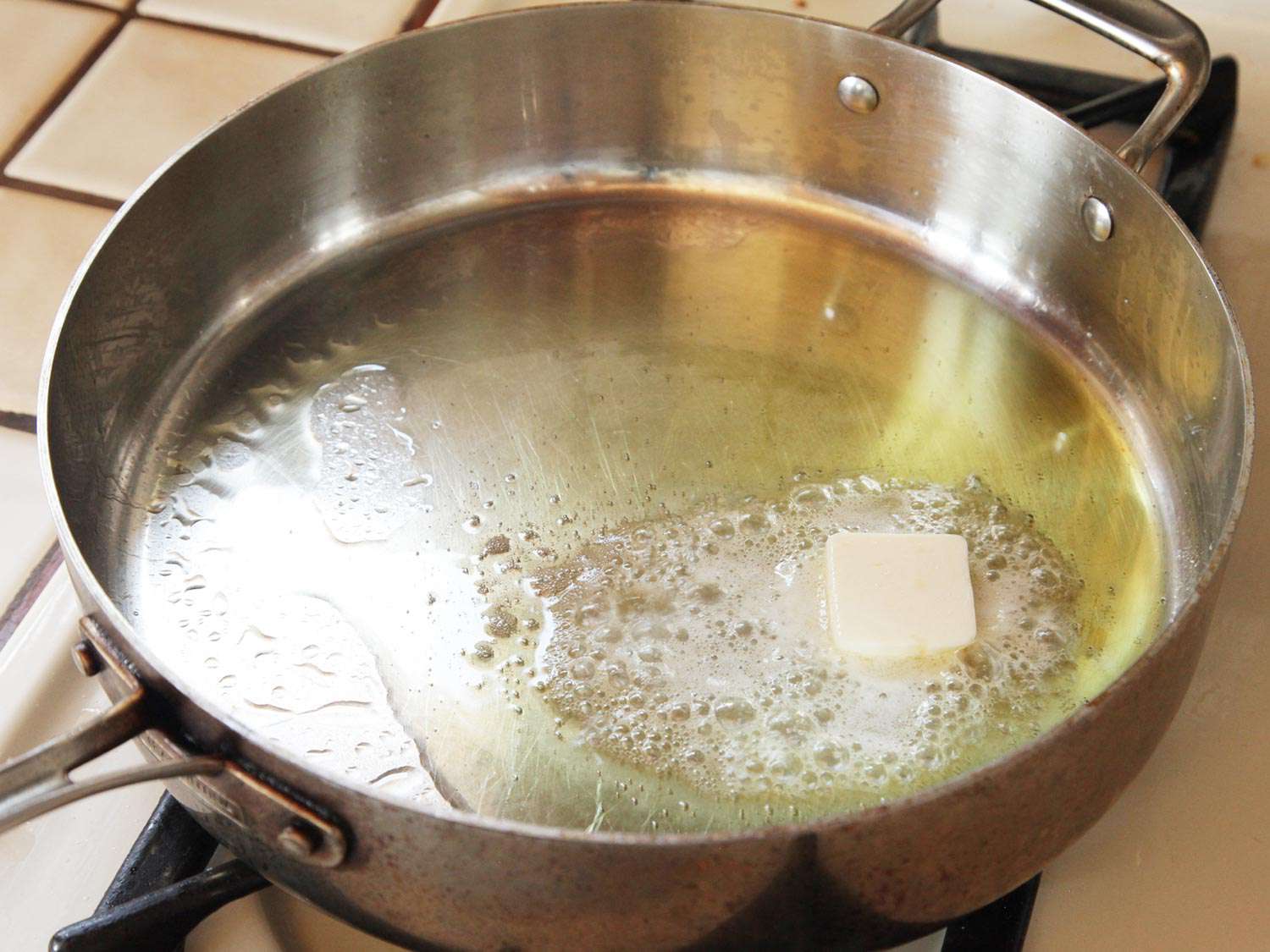 Butter foaming and melting in a large sauté pan with olive oil. 