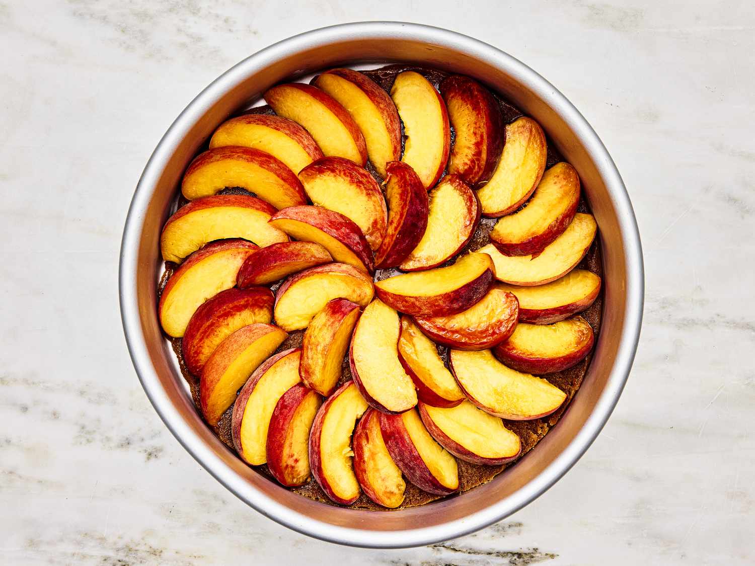 Overhead view of peaches in a pan