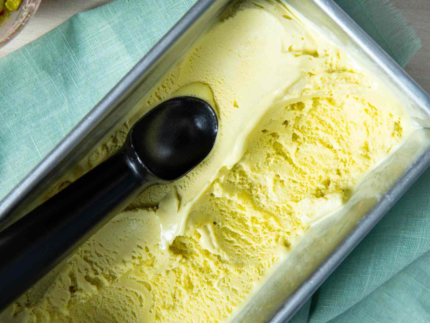 A loaf pan filled with pistachio ice cream.
