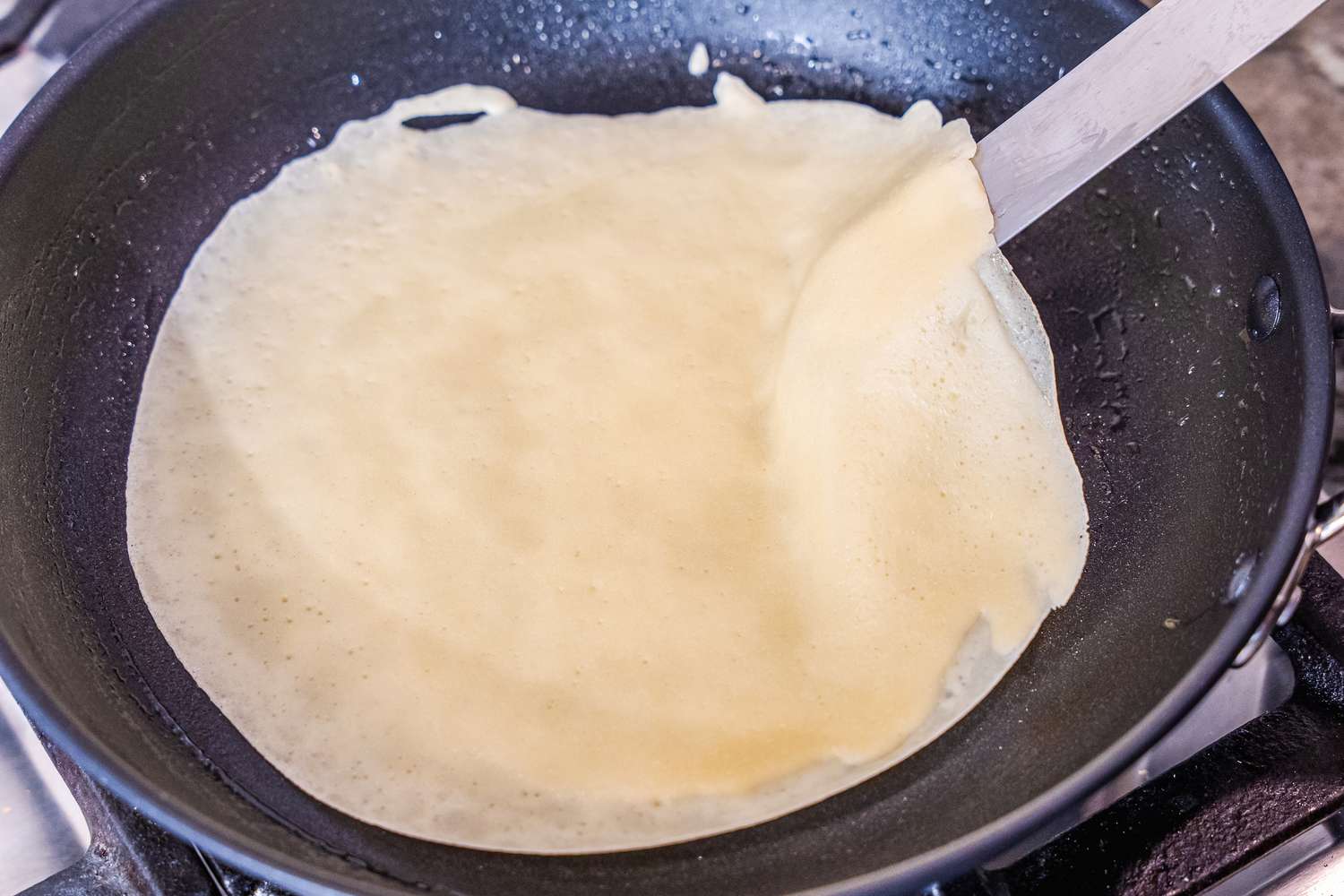 A crepe cooking in the Misen Nonstick Pan