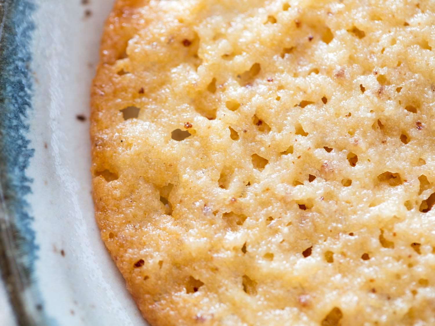Close up of lacy surface texture of ricotta-brown butter cookies.