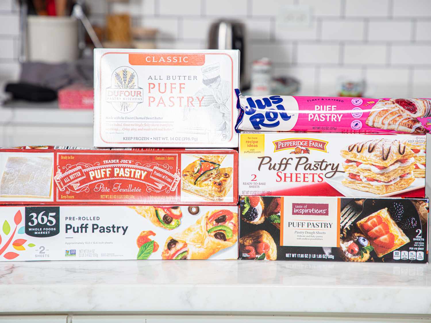 A collection of various puff pastry packages arranged on a kitchen counter