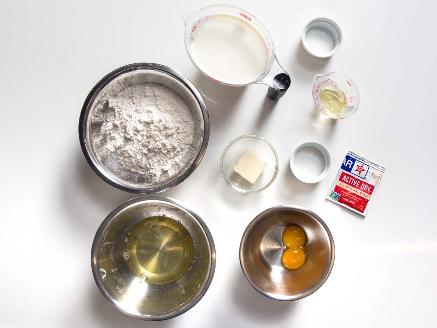 Yeasted blini ingredients on a white surface.