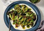Overhead view of charred broccoli with taleggio cheese sauce