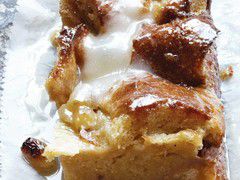 A slice of bourbon bread pudding drizzled with creamy bourbon butter glaze