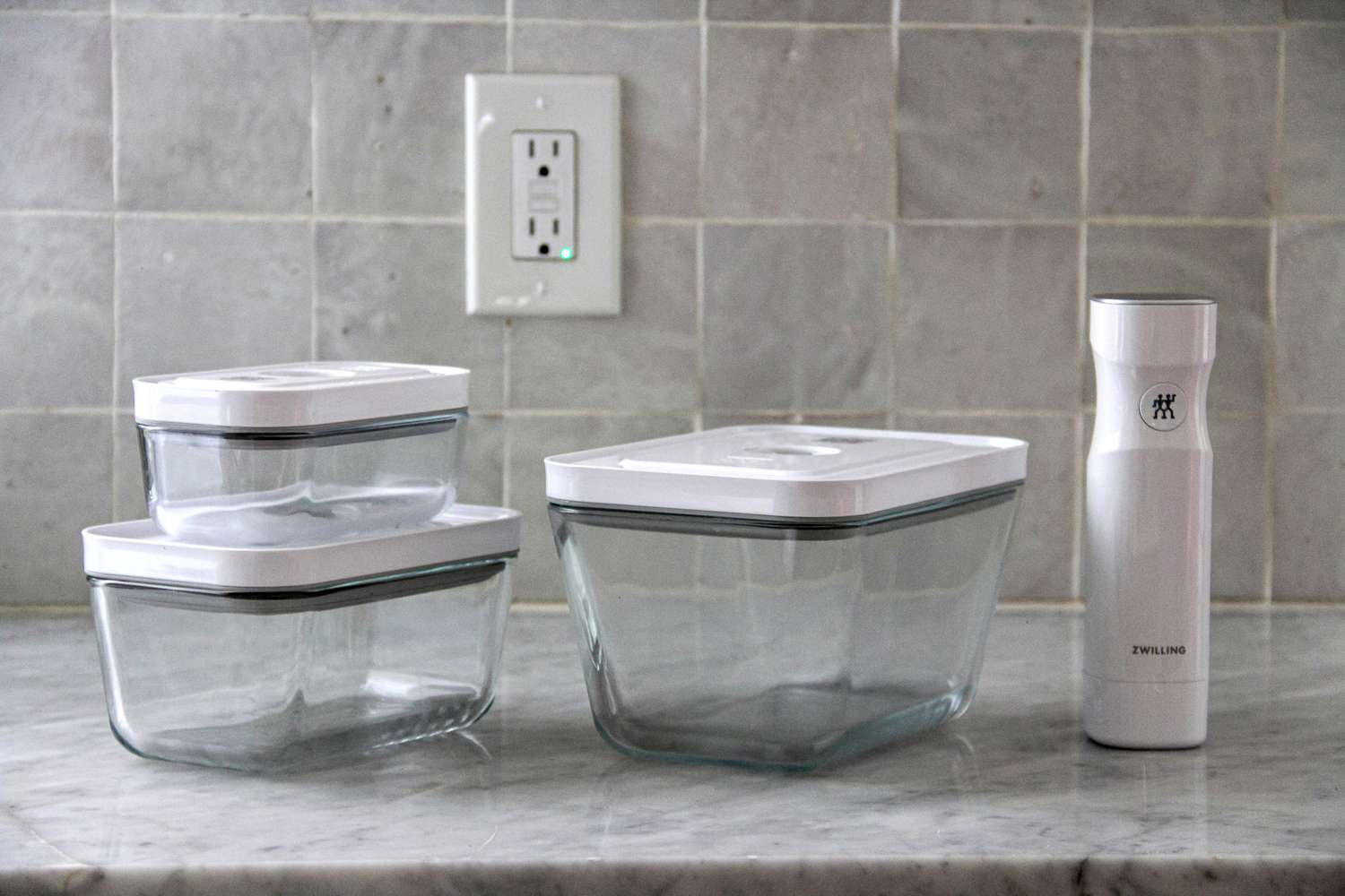 Set of Zwilling Glass Food Storage Container + Vacuum Sealer Pump on a marble countertop