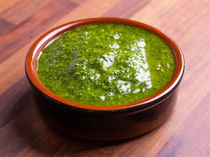 Closeup of a ramekin full of fennel frond pesto.