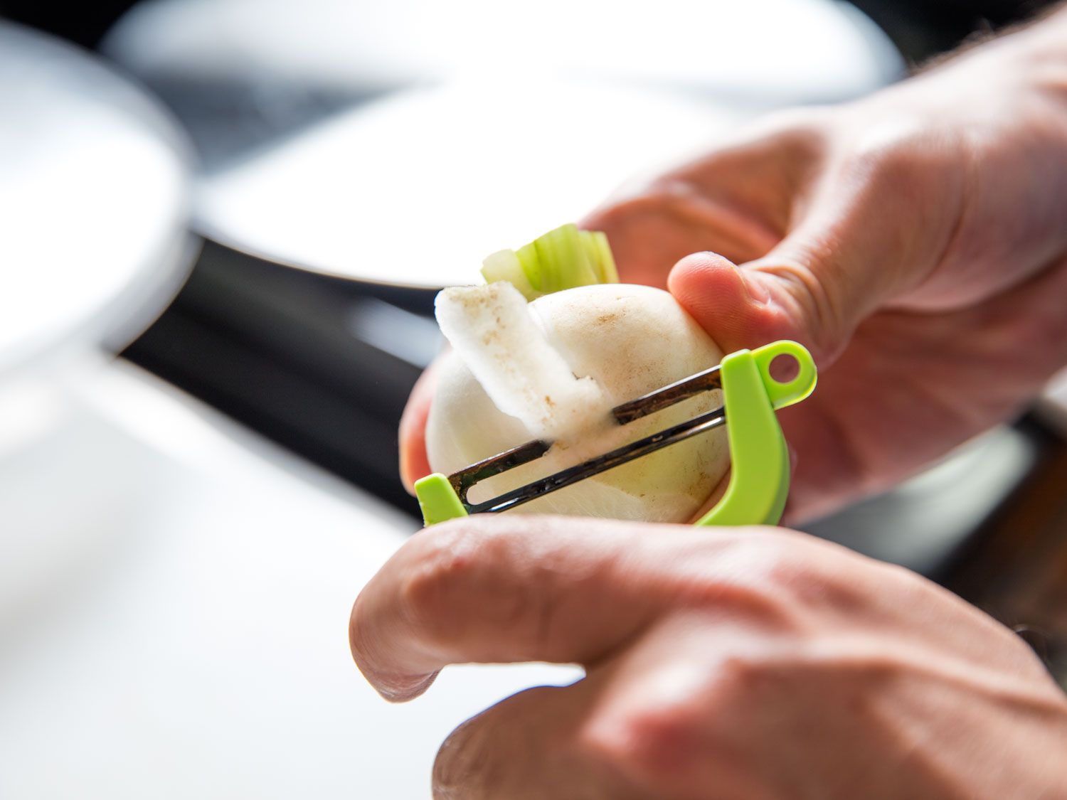 Peeling Hakurei (Japanese) turnip with a vegetable peeler.