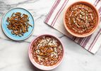 Overhead view of two bowls of Champorado and a side plate of candied anchovies