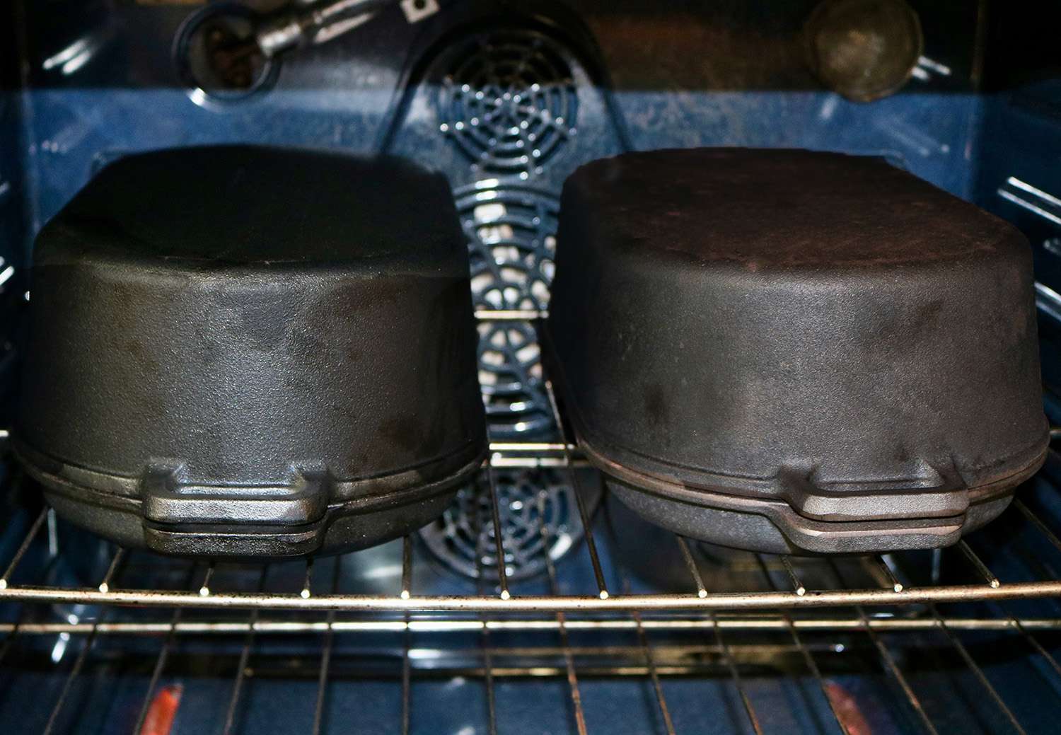 two Pit Boss Cast Iron Roasters sit in an oven side by side