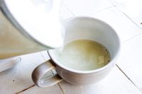 pouring nut milk into a mug