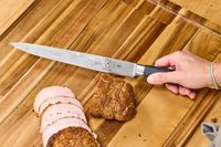 A person slices meat using the Mercer Culinary 10-Inch Carving Knife