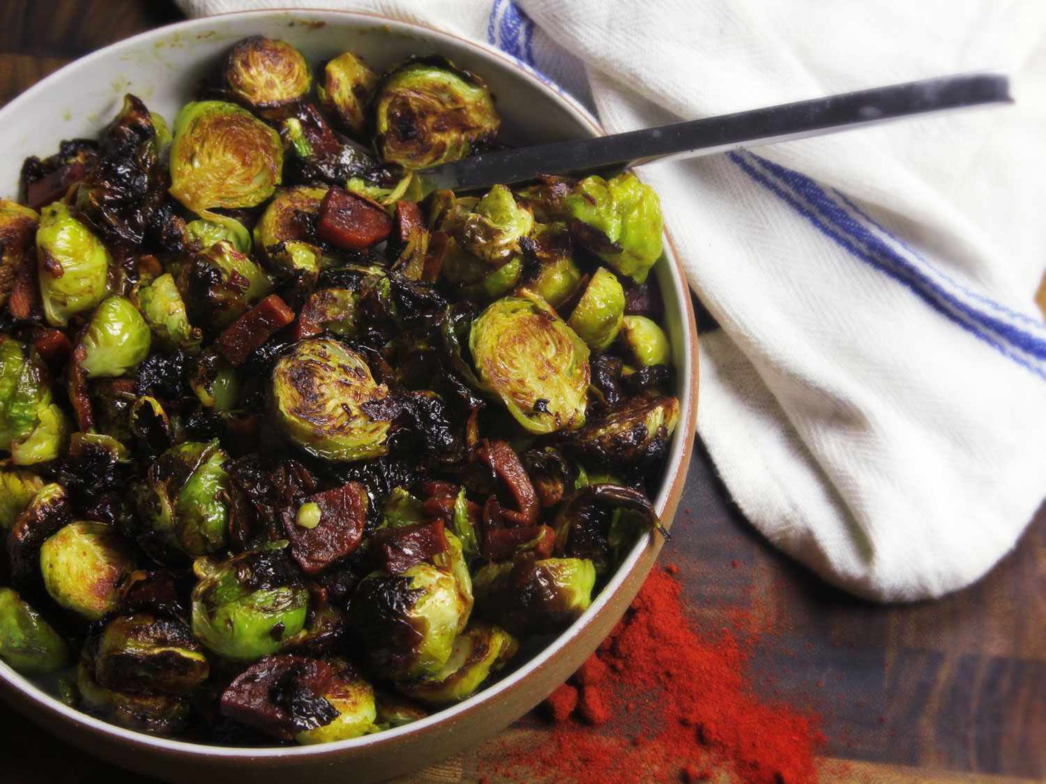 Roasted Brussels Sprouts With Chorizo and Sherry Vinegar, served in a white bowl.
