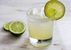 Classic margarita in rocks glass with lime wheel on salted rim