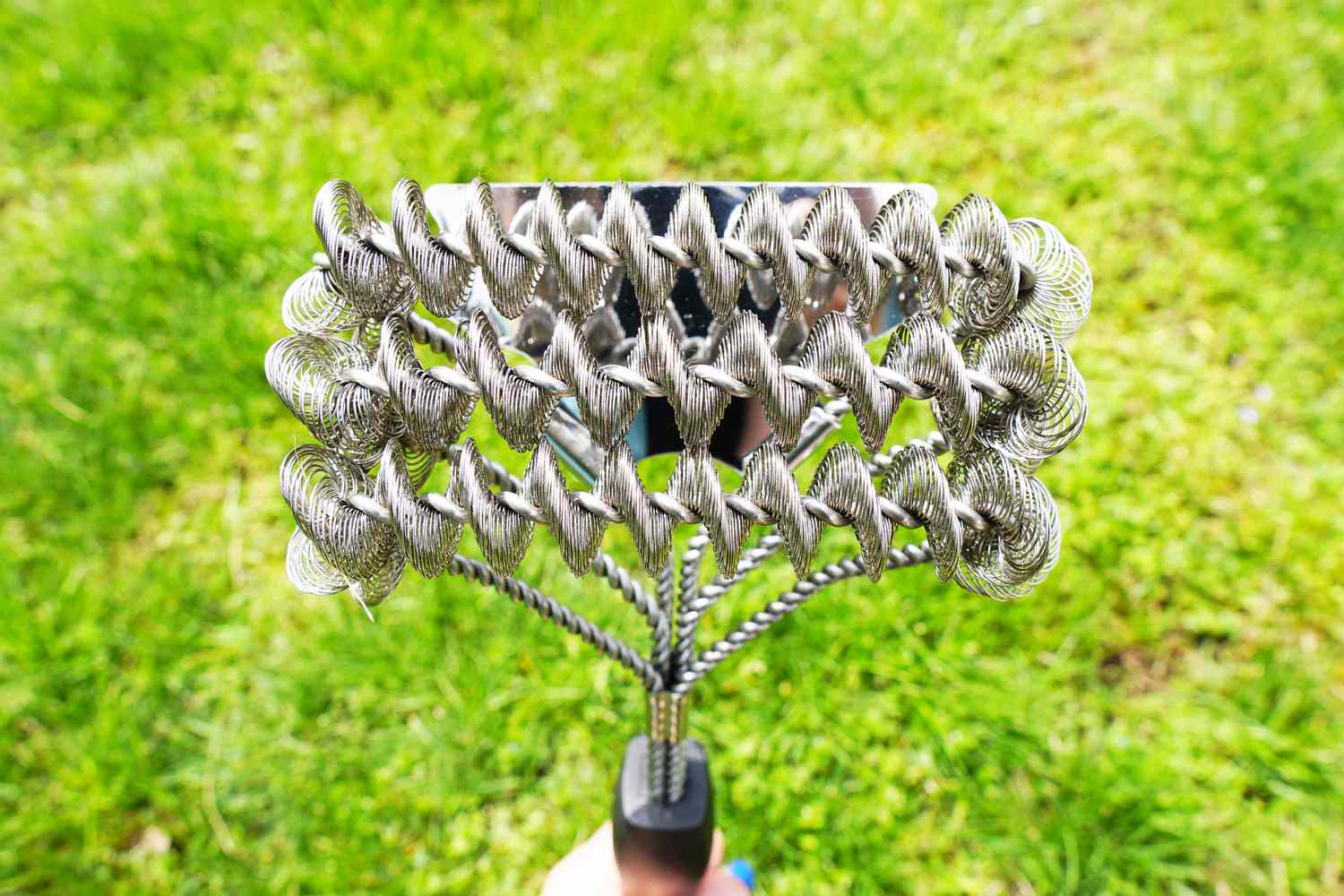 a closeup look at a coiled grill brush's head