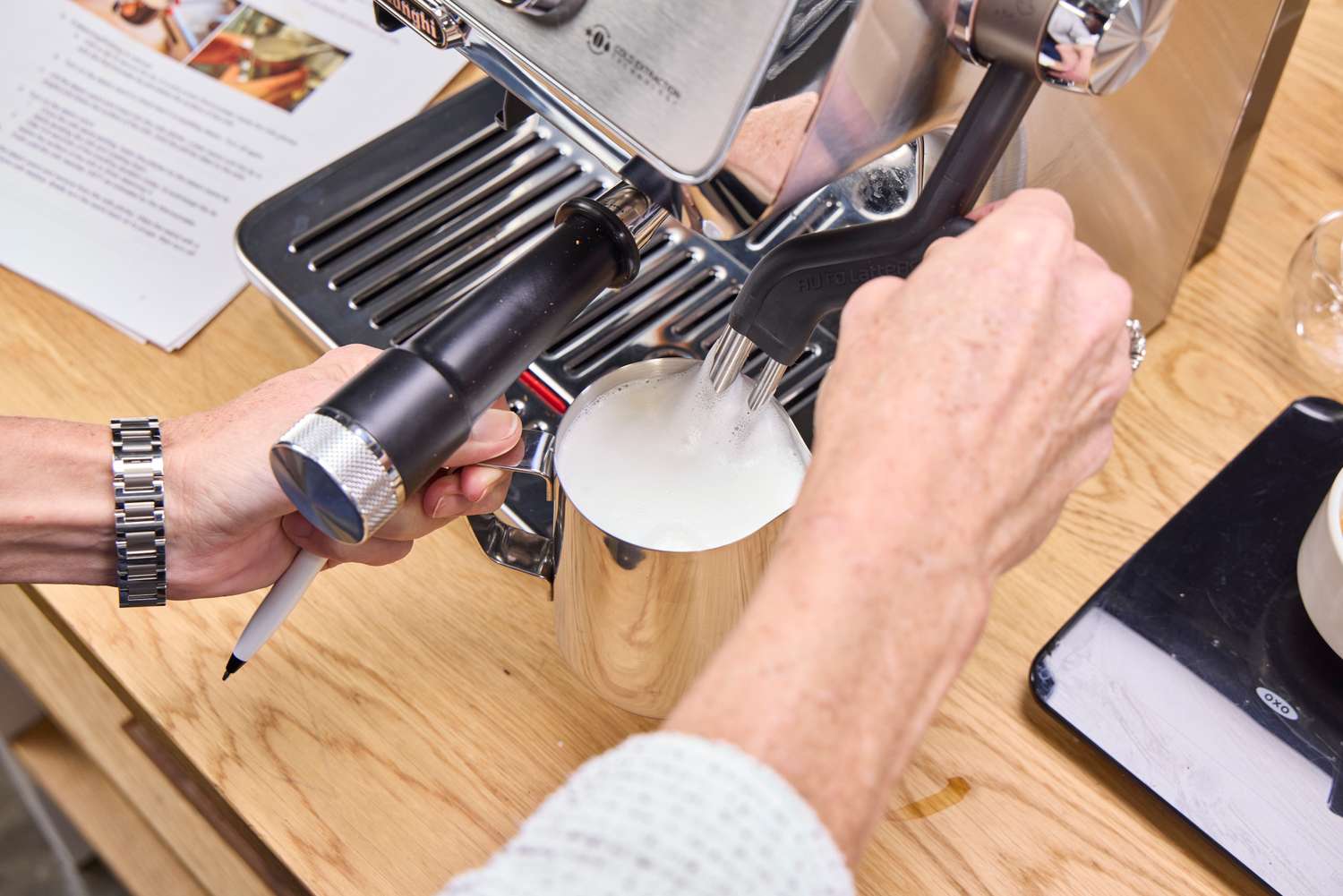 A person steams milk using the De'Longhi La Specialista Touch Espresso Machine
