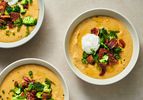 Three bowls of fully loaded vegan baked potato soup